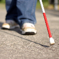 image of a person using a white cane.